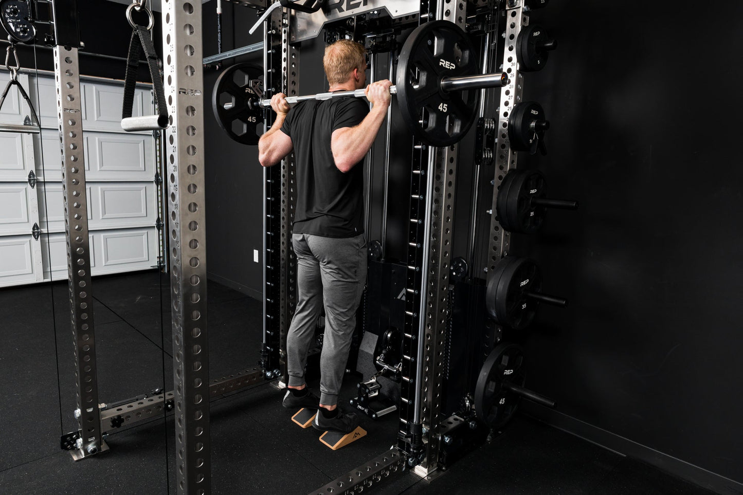 Athlete doing calf raises on the Smith Machine inside a power rack